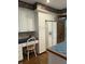 Well-lit kitchen featuring white cabinets, chair and a refrigerator with water dispenser at 1304 Park Meadow Dr, Beech Grove, IN 46107