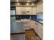 Bright kitchen with white cabinets, tiled countertops and modern appliances at 1304 Park Meadow Dr, Beech Grove, IN 46107