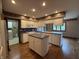 Spacious kitchen with island, tiled countertops and views to laundry room and yard at 1304 Park Meadow Dr, Beech Grove, IN 46107