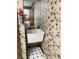 Laundry room with patterned floor, floral wallpaper, sink and fire extinguisher at 1304 Park Meadow Dr, Beech Grove, IN 46107