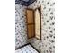Classic laundry room featuring floral wallpaper, patterned floor, and ironing board at 1304 Park Meadow Dr, Beech Grove, IN 46107