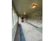Enclosed sunroom featuring brick walls, multiple windows, carpet, and overhead lighting at 1304 Park Meadow Dr, Beech Grove, IN 46107
