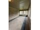 Enclosed sunroom featuring brick walls, multiple windows, carpet, and overhead lighting at 1304 Park Meadow Dr, Beech Grove, IN 46107