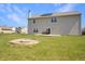 The backyard features a well-maintained lawn, a fire pit, and a rear patio at 1416 Gleneagle Dr, Indianapolis, IN 46239