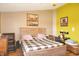This primary bedroom features a decorative bedframe, a desk, and a seating area at 1416 Gleneagle Dr, Indianapolis, IN 46239
