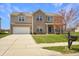 Charming two-story home with a well-manicured lawn, brick accents, and a convenient two-car garage at 1416 Gleneagle Dr, Indianapolis, IN 46239