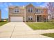 Inviting two-story home showcasing a lush lawn, brick facade, and a spacious two-car garage at 1416 Gleneagle Dr, Indianapolis, IN 46239