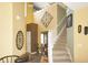 The foyer features high ceilings, decorative wall art, and a staircase leading to the upper level at 1416 Gleneagle Dr, Indianapolis, IN 46239
