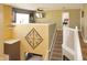 Hallway with decorative art and staircase to a bonus room with a TV at 1416 Gleneagle Dr, Indianapolis, IN 46239