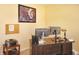 The home office has two monitors, a printer and lovely wall art at 1416 Gleneagle Dr, Indianapolis, IN 46239