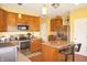 Bright kitchen with a center island, stainless steel appliances, and an adjacent dining area at 1416 Gleneagle Dr, Indianapolis, IN 46239