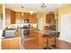 Bright kitchen features stainless appliances, central island with bar stools, and honey colored cabinetry at 1416 Gleneagle Dr, Indianapolis, IN 46239