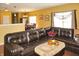 Open-concept living room features a cozy leather sectional sofa with great natural light at 1416 Gleneagle Dr, Indianapolis, IN 46239