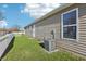 This property has a well-maintained backyard with a green lawn, AC unit, and access to nearby streets at 14226 Marilyn Rd, Noblesville, IN 46060