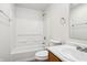Bright bathroom features a shower-tub combo with sleek, modern fixtures and a crisp, white finish at 14226 Marilyn Rd, Noblesville, IN 46060