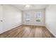 Bedroom featuring wood-look flooring, a ceiling fan, and two windows with natural light at 14226 Marilyn Rd, Noblesville, IN 46060