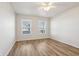Spacious bedroom featuring wood-look floors and two windows that provide natural light at 14226 Marilyn Rd, Noblesville, IN 46060