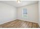 Bright bedroom features wood-look floors and a window that provides natural light at 14226 Marilyn Rd, Noblesville, IN 46060