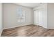Bedroom featuring neutral paint, wood-look floors, large window, and closet with sliding doors at 14226 Marilyn Rd, Noblesville, IN 46060