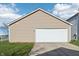 Garage features ample parking space with a wide driveway and is surrounded by green grass and blue skies at 14226 Marilyn Rd, Noblesville, IN 46060