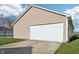 View of a detached two car garage with wide driveway, with green lawn in a bright, sunny neighborhood at 14226 Marilyn Rd, Noblesville, IN 46060