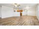 Open-concept living area featuring wood-look flooring, a ceiling fan, and neutral paint colors at 14226 Marilyn Rd, Noblesville, IN 46060