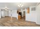 Spacious living room with wood-look floors, ceiling fan, and easy access to the kitchen at 14226 Marilyn Rd, Noblesville, IN 46060
