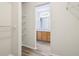 Walk-in closet leads to a bathroom with a wood vanity and plenty of shelving space at 14226 Marilyn Rd, Noblesville, IN 46060