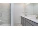 Bathroom featuring a double vanity with stylish lighting and glass enclosed tiled shower at 14538 Hanford Ln, Carmel, IN 46074