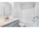 Well-lit bathroom featuring a vanity with sink, shower, and toilet at 14538 Hanford Ln, Carmel, IN 46074