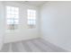 Well-lit bedroom with neutral carpet and two windows offering natural light and views of the outdoors at 14538 Hanford Ln, Carmel, IN 46074