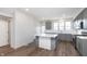 Spacious kitchen with an island, gray cabinets, stainless appliances, and bright, modern finishes at 14538 Hanford Ln, Carmel, IN 46074