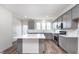 New kitchen with an island, stainless steel appliances, gray cabinetry, and white subway tile backsplash at 14538 Hanford Ln, Carmel, IN 46074