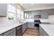 Modern kitchen with bright lighting, gray cabinets, stainless appliances, and a tiled backsplash at 14538 Hanford Ln, Carmel, IN 46074