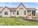 The groomed backyard features a stone terrace and covered back porch area with sunshades at 1501 Chanson Ln, Westfield, IN 46074