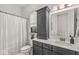 This well-lit bathroom boasts a combination tub and shower, vanity, and is equipped with a decorative cabinet at 1501 Chanson Ln, Westfield, IN 46074