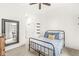 A cozy bedroom featuring neutral walls, a bed with patterned bedding, and dark shelving at 1501 Chanson Ln, Westfield, IN 46074