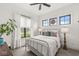 This cozy bedroom features bright windows, neutral bedding, and a ceiling fan for added comfort and style at 1501 Chanson Ln, Westfield, IN 46074