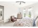 Bright primary bedroom with ceiling fan, large windows and hardwood dresser at 1501 Chanson Ln, Westfield, IN 46074