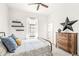This bedroom features neutral decor, wooden dresser, and ceiling fan for a cozy and inviting atmosphere at 1501 Chanson Ln, Westfield, IN 46074