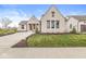 Charming single-Gathering home boasts a brick exterior, manicured lawn, and an attached garage at 1501 Chanson Ln, Westfield, IN 46074