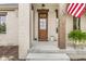 Charming home front entrance boasts a wooden door, painted brick, and an American flag at 1501 Chanson Ln, Westfield, IN 46074