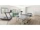 Well-lit game room with a treadmill, storage cabinet, ping pong table, and windows at 1501 Chanson Ln, Westfield, IN 46074