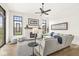 Bright living room with fireplace, large windows, ceiling fan and light gray sectional sofa at 1501 Chanson Ln, Westfield, IN 46074