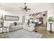 Spacious living room leading into the kitchen with a light gray sectional sofa and decorative fireplace at 1501 Chanson Ln, Westfield, IN 46074