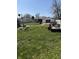 Spacious backyard with lawn care equipment, deer statue, and lush green grass at 1623 S Grant Ave, Indianapolis, IN 46203