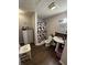 Bathroom boasts wood floors, updated vanity, and shower with a geometric curtain at 1623 S Grant Ave, Indianapolis, IN 46203