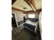 Bedroom featuring two twin beds, a window, and an ensuite bathroom at 1623 S Grant Ave, Indianapolis, IN 46203