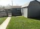 View of a fenced backyard with grass and a shed for extra storage at 1722 N Parker Ave, Indianapolis, IN 46218