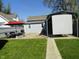 Backyard featuring a patio, seating, covered parking, and lawn at 1722 N Parker Ave, Indianapolis, IN 46218